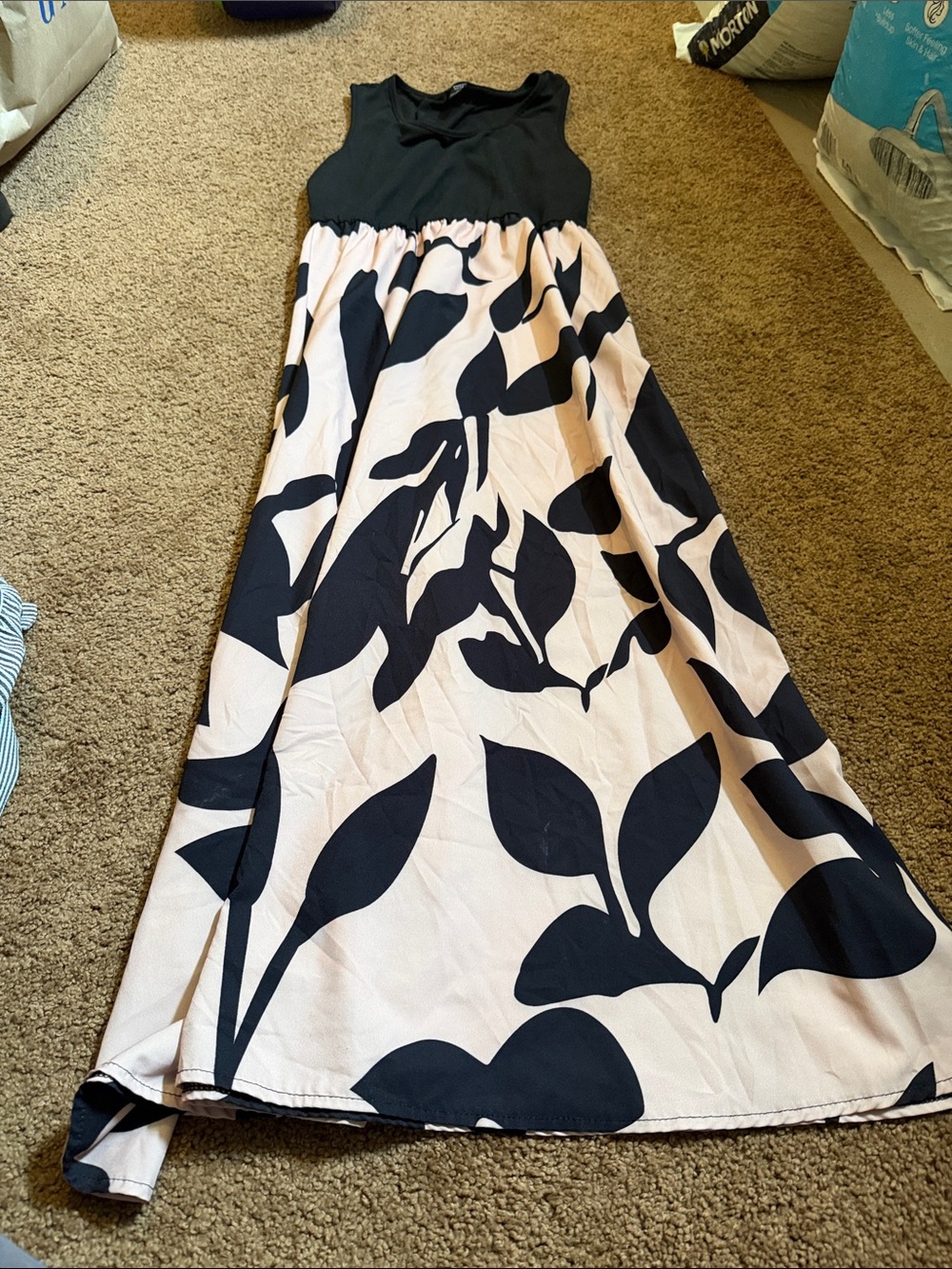 Sleeveless Black Bodice Cream Maxi Dress with Bold Black Floral Print